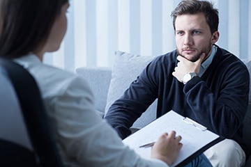 Counselling session for a man in need of therapy.