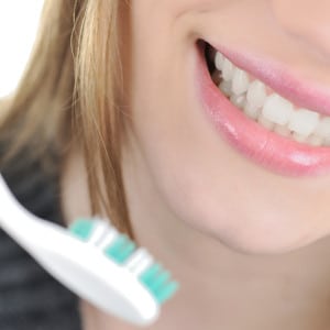 Woman with toothbrush representing dentistry.