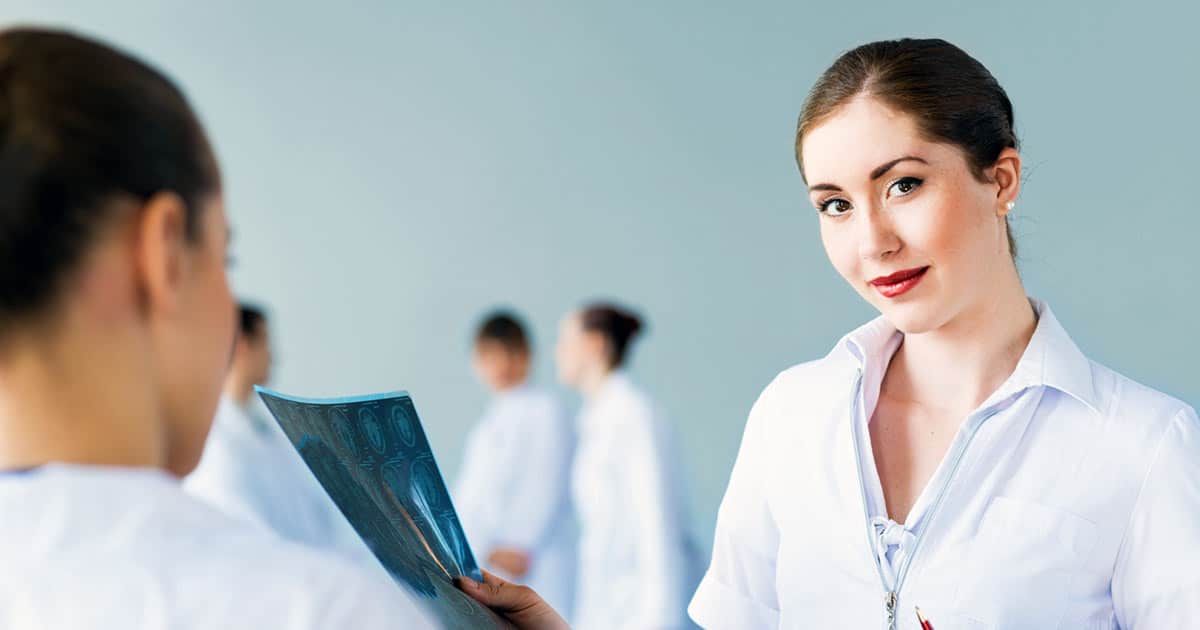 Nurses consulting over an x-ray