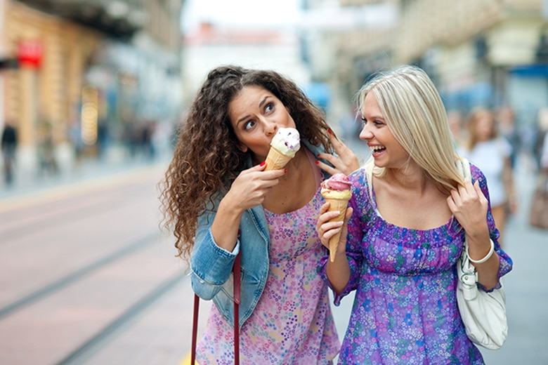 Two young women eating ice-cream