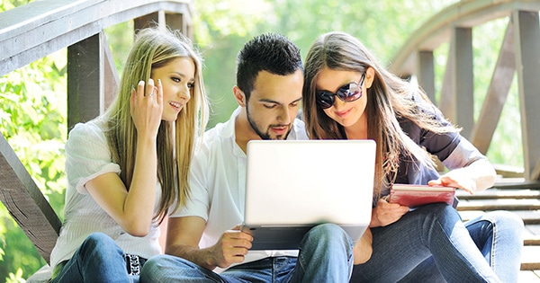 Technology on campus: students using a laptop.