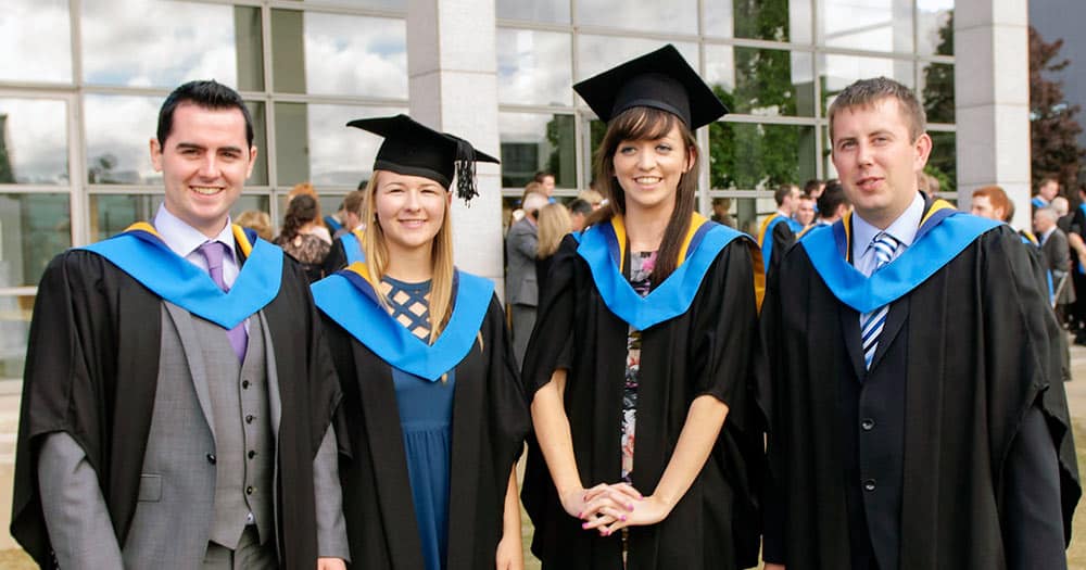 Group of four university graduates